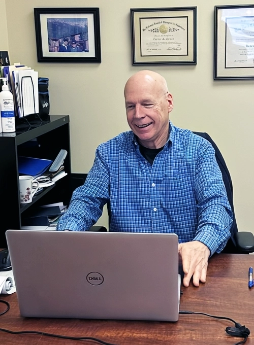 Chiropractor Middlebury VT Dr. Curtis Gross at His Desk